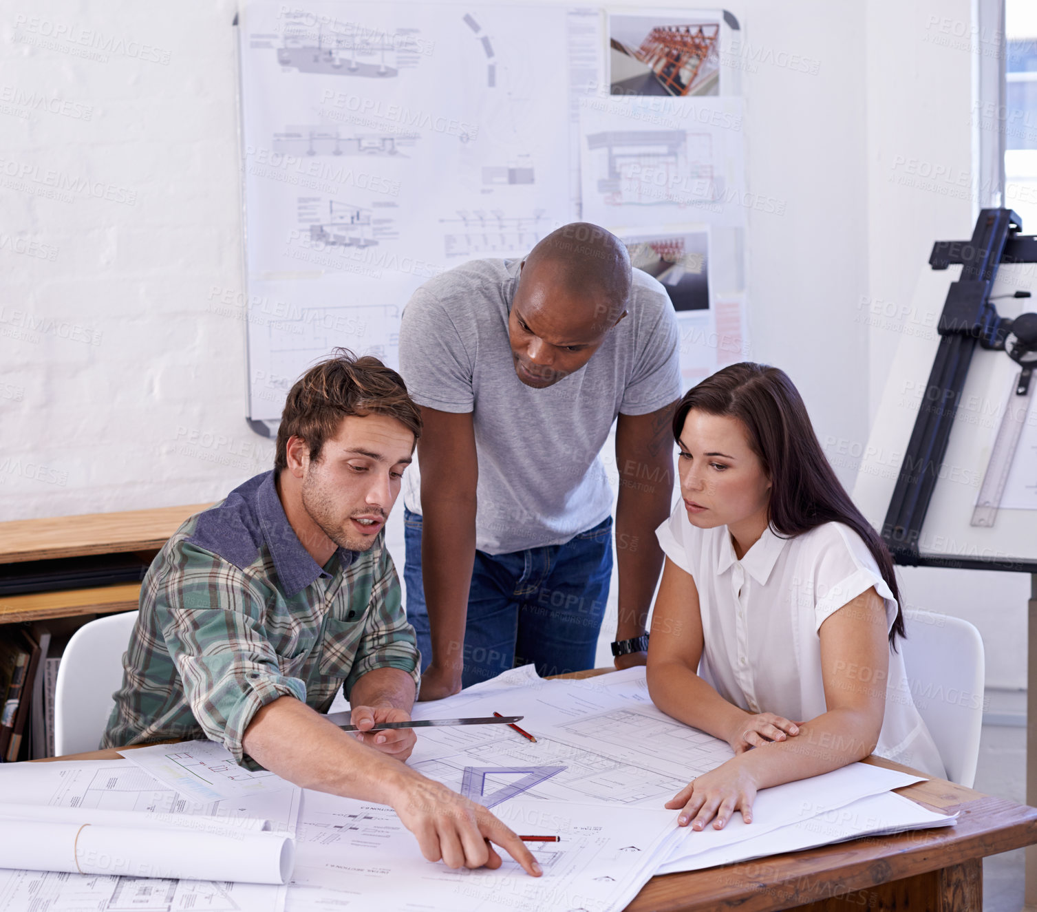 Buy stock photo Shot of a young team of architects working together in the office
