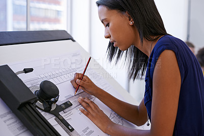 Buy stock photo Cropped shot of an attractive female architect working at a drawing board