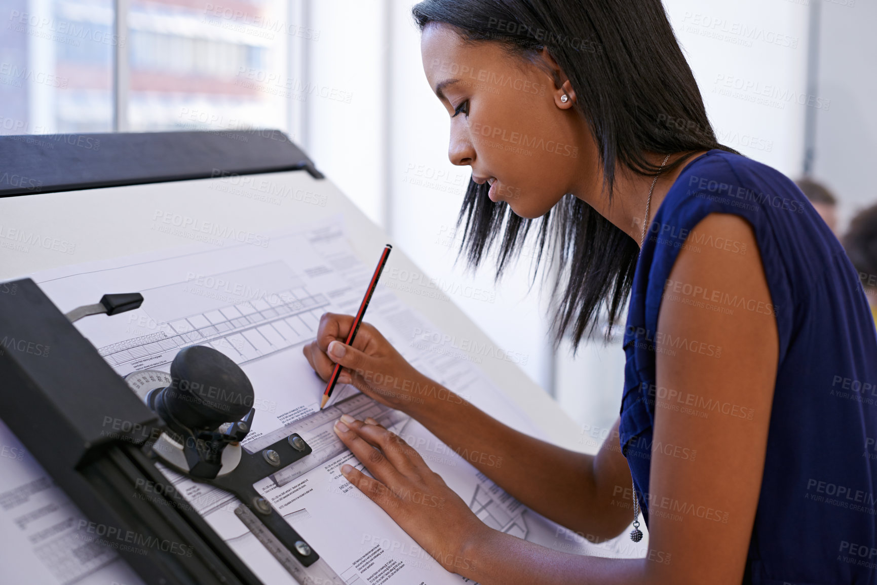 Buy stock photo Cropped shot of an attractive female architect working at a drawing board