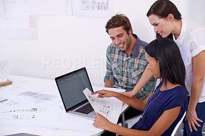 Buy stock photo Shot of a group of young architects working together in the office