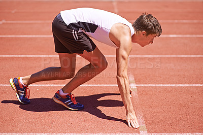 Buy stock photo Man, athlete and start running on race track for fitness, sports and focus for speed and action outdoor. Exercise, workout and training at stadium or arena, cardio and health with fast runner