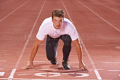 Buy stock photo Man, athlete and start running on race track for exercise, sports and focus for speed and action outdoor. Fitness, workout and training at stadium or arena, cardio and health with fast runner