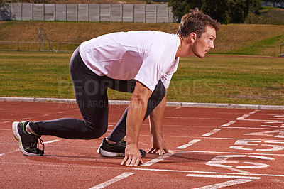 Buy stock photo Man, athlete and start run on race track for exercise, sports and focus for speed and action outdoor. Fitness, workout and training at stadium or arena, cardio and health with fast runner or sprinter