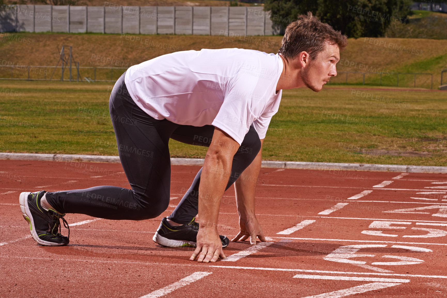 Buy stock photo Man, athlete and start run on race track for exercise, sports and focus for speed and action outdoor. Fitness, workout and training at stadium or arena, cardio and health with fast runner or sprinter