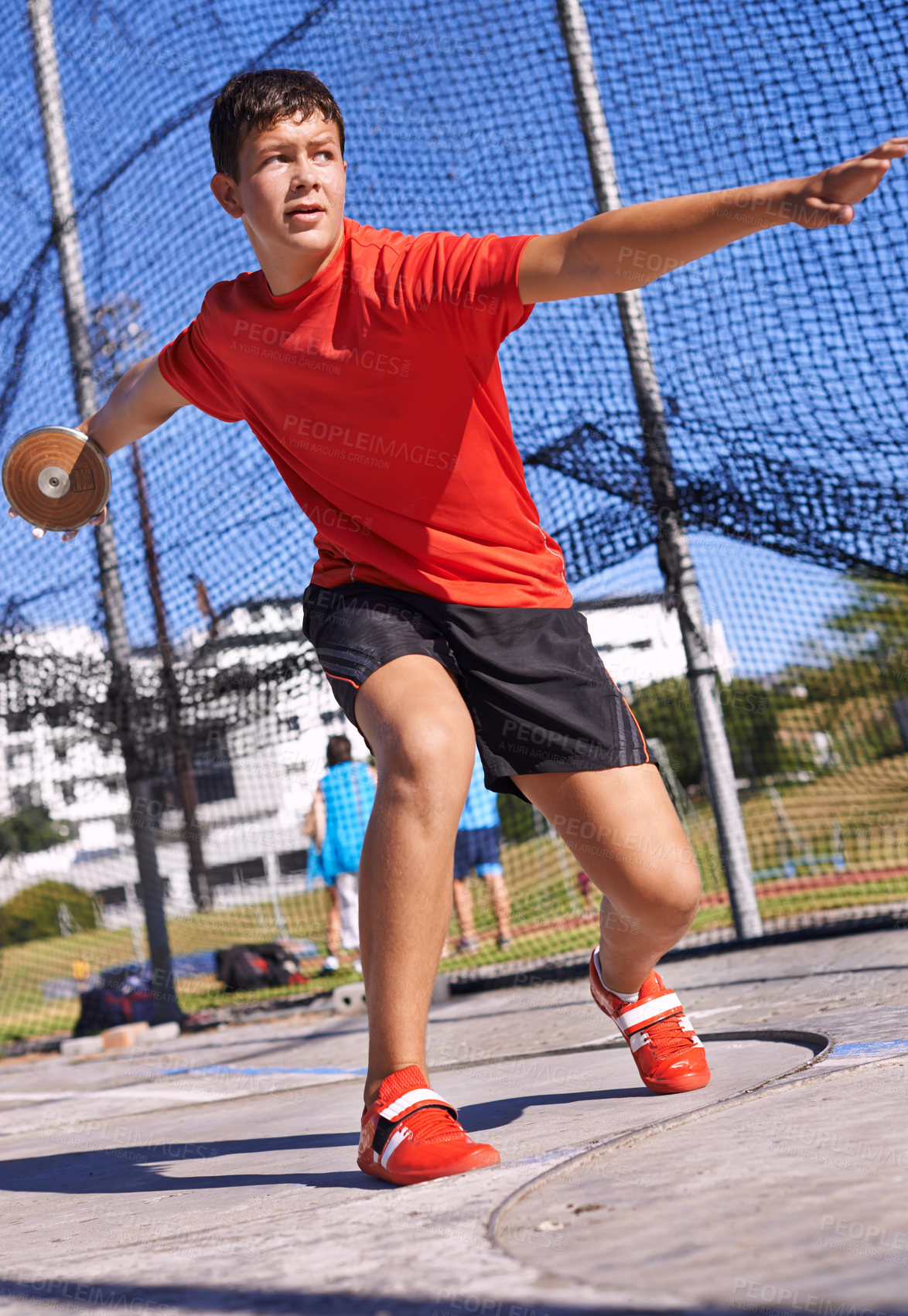 Buy stock photo Discus, young man and sportsman throw in competition, championship or training for outdoor field event. Sports, metal disc and male person for fitness, athletics and tournament in strong contest