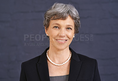 Buy stock photo Cropped shot of a senior businesswoman standing in front of a brick wall