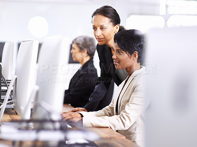Buy stock photo Shot of three businesswomen working in an office