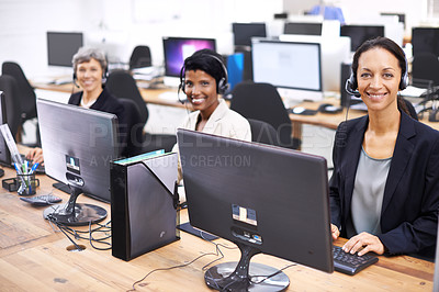 Buy stock photo Cropped shot of three female call center representatives wearing headsets