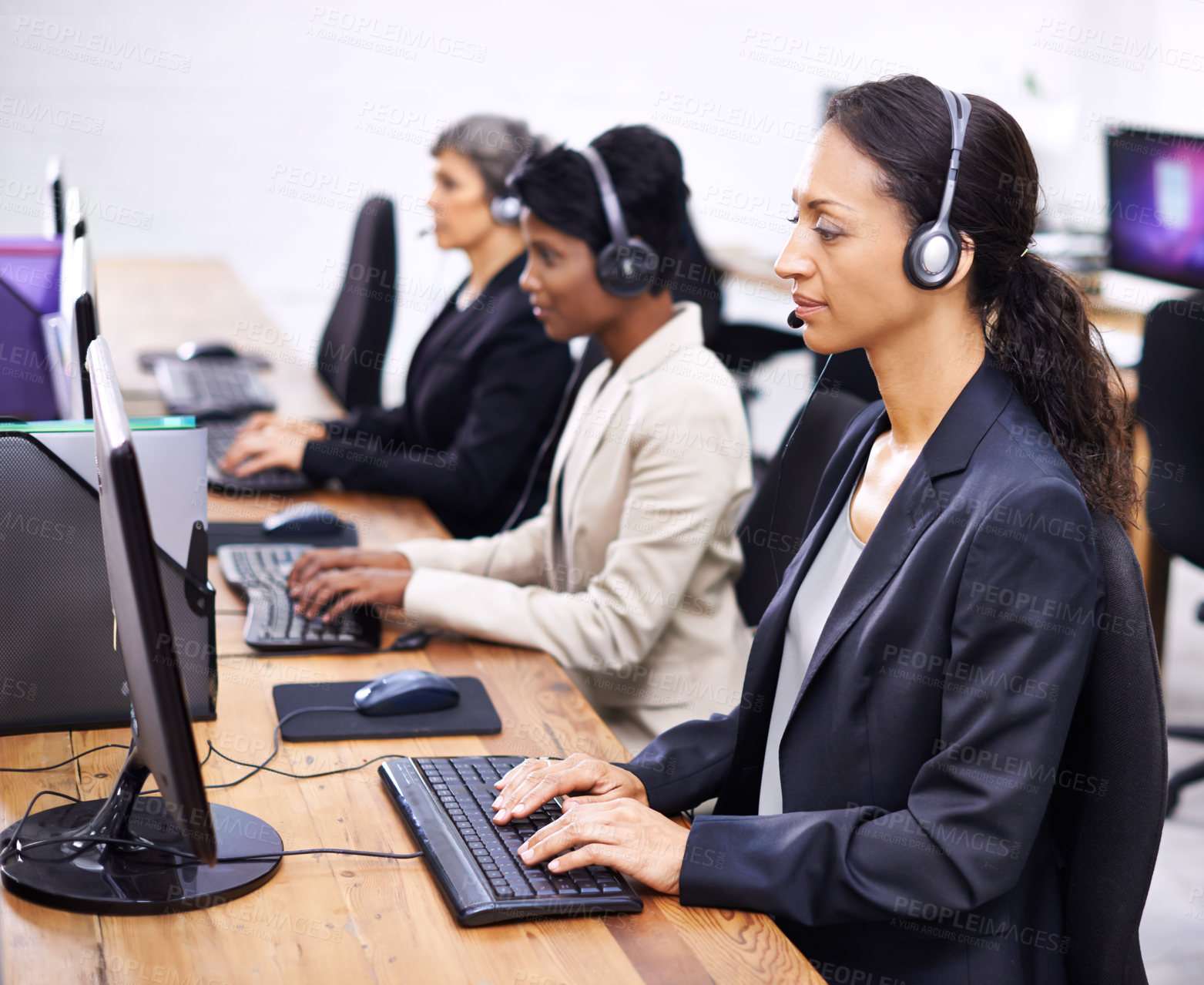 Buy stock photo Cropped shot of three female call center representatives wearing headsets