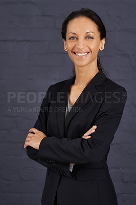 Buy stock photo Portrait of a confident businesswoman standing with her arms crossed