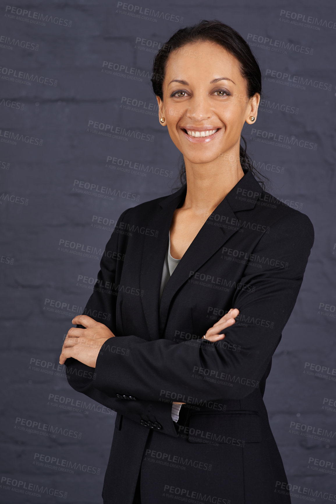Buy stock photo Portrait of a confident businesswoman standing with her arms crossed