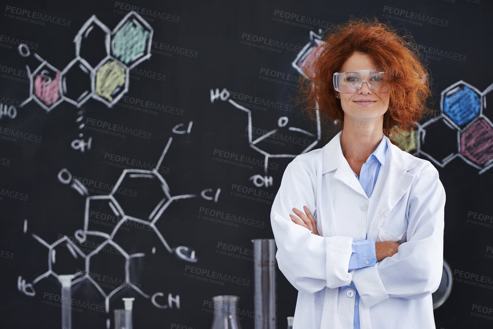 Buy stock photo A messy-haired female scientist standing in her lab proudly