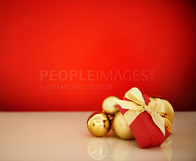 Buy stock photo Studio shot of Christmas ornaments against a red background