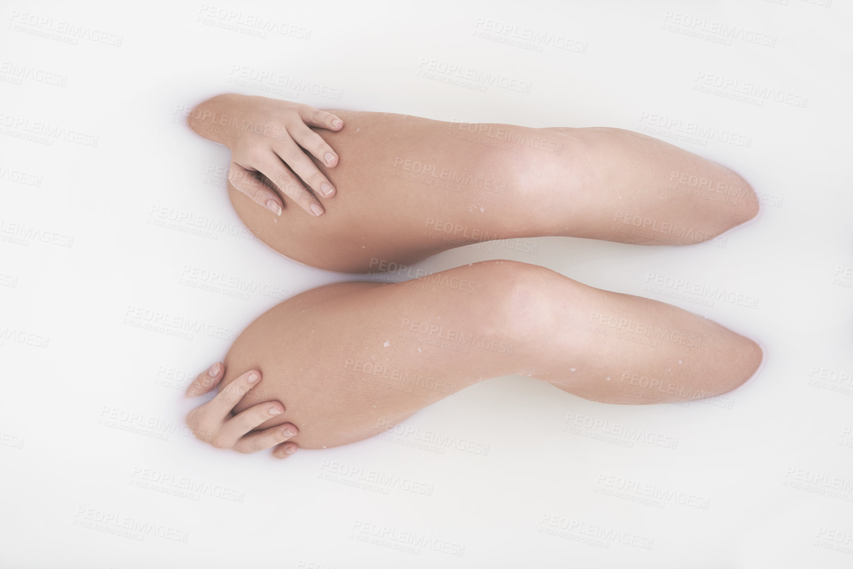 Buy stock photo Cropped shot of a woman's legs in a milky bath