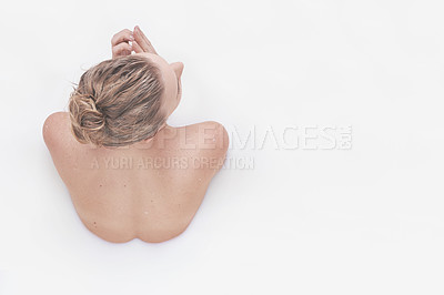 Buy stock photo Rear view of a woman partially submerged in a white liquid