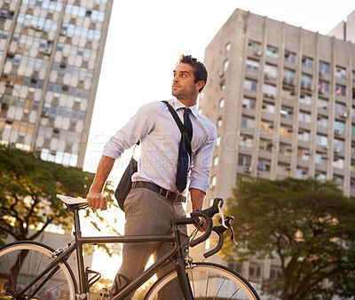 Buy stock photo Cycling, commute and business man in city for morning, carbon neutral and transportation. Sustainable, professional and travel with male employee walking with bike in urban town for journey and trip