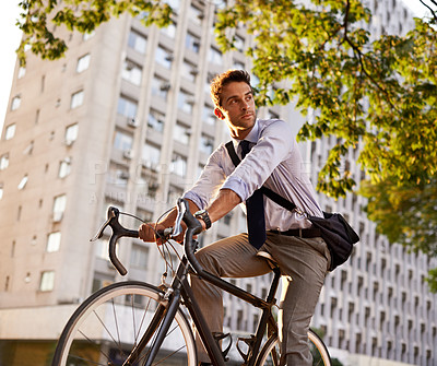 Buy stock photo Cycling, bicycle and business man in city for commute, carbon neutral and transportation. Sustainable, professional and travel with male employee riding on bike in urban town for journey and trip