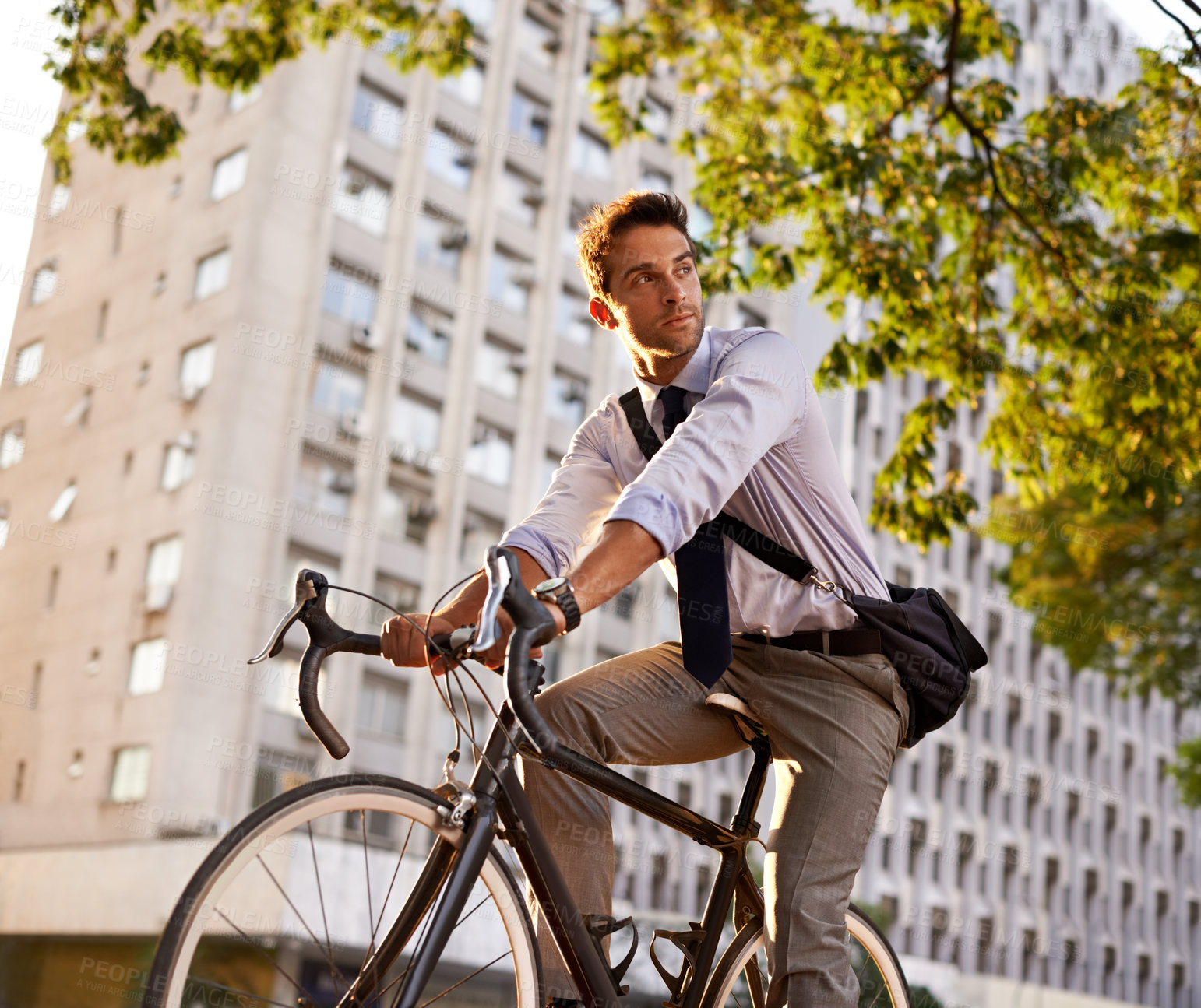 Buy stock photo Cycling, bicycle and business man in city for commute, carbon neutral and transportation. Sustainable, professional and travel with male employee riding on bike in urban town for journey and trip