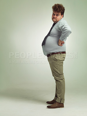 Buy stock photo Business man, portrait and plus size with unhappy, sad and frustrated in studio with arms on hips. Job, employee and office fashion with problem and clothing with green background and moody from work