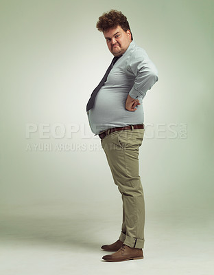 Buy stock photo Business man, portrait and plus size with funny, joke and silly in a studio with arms on hips. Goofy, employee and office fashion with fun and modern clothing with green background and humor