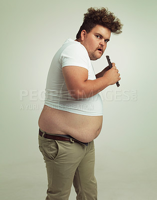 Buy stock photo Chocolate, portrait and plus size man with eating food, dessert and candy in a studio. Nutrition, sweet and unhealthy snack with sneaky and secret with a hungry male person with green background
