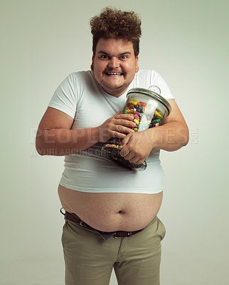Buy stock photo Candy, crazy and portrait of plus size man on white background for snacks, sweets and dessert in container. Comic, funny and isolated person with glass jar for unhealthy diet and sugar in studio