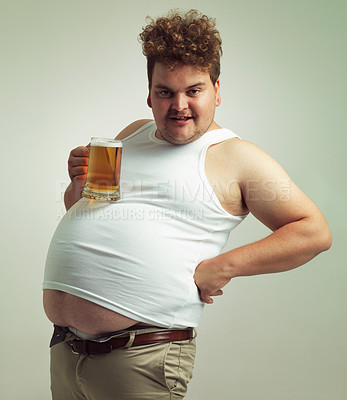Buy stock photo Obese, weight gain and lager for man in studio with drink for unhealthy habit, plus size and joke. Overweight person with glass on fat stomach for balance, drunk and humor for alcohol and comic