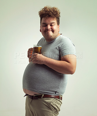 Buy stock photo Obesity, weight gain and lager for man in studio with drink for unhealthy habit, plus size and joke. Overweight person with glass on fat stomach for balance, drunk and humor for alcohol and comic

