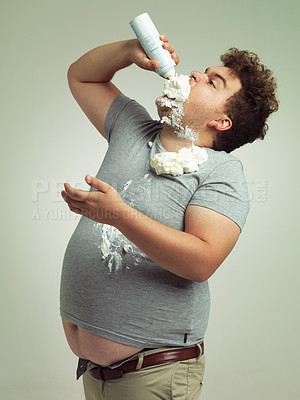 Buy stock photo Sweet, dessert and man with whipped cream for eating in studio background, addiction and unhealthy for plus size male person. Guy, health problem and risk for diabetes with sugar and cholesterol
