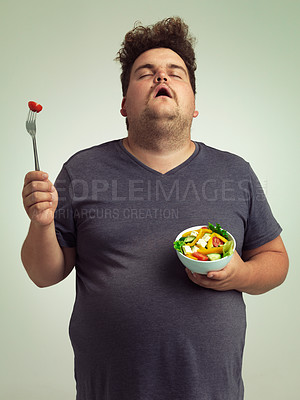Buy stock photo Plus size man, salad and diet with healthy food with fork, bowl and vegetables for wellness on studio background. Male person, frustrated and lose weight for health, eating disorder and nutrition