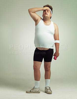 Buy stock photo Plus size, tired man and dumbbells for exercise, training or workout in studio isolated on a white background mockup space. Body, fatigue and person on break with weights for muscle, fitness or rest