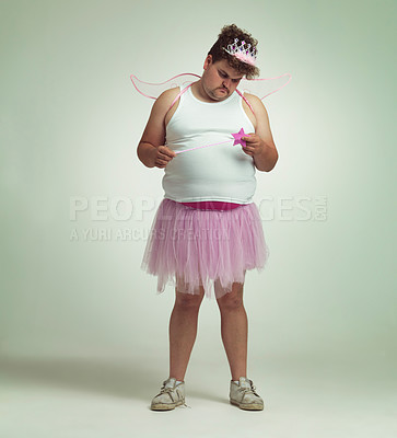 Buy stock photo Fairy, man and studio portrait for magic and isolated, sad male person with wings and pretend costume. Pink Cosplay, depressed and mature plus size model, dress up or role play on white background