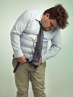 Buy stock photo Plus size, fitting and man unhappy with pants, shirt and professional clothes or suit for work. Adult, guy and male person with stomach or belly, upset and feeling frustrated with outfit for job