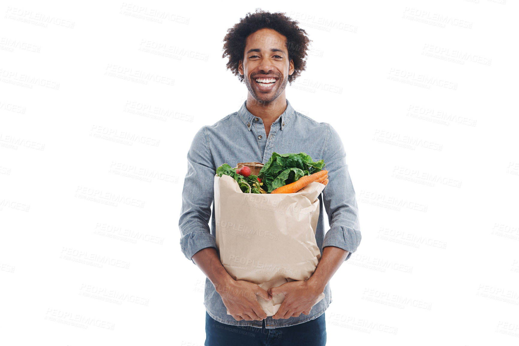 Buy stock photo A handsome young black man holding groceries