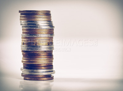 Buy stock photo Closeup, studio and stack of coins for saving, budgeting and counting money in recession or retrenchment. Bronze, silver and change to bank for small investment and illustration of  value of money