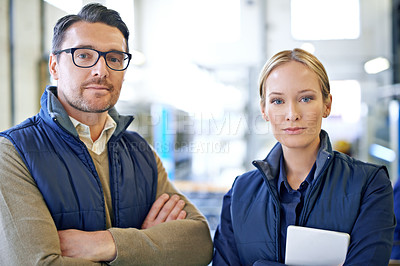 Buy stock photo Colleagues, man and woman with tablet, portrait and serious for delivery in warehouse of factory. Teamwork, girl and male person in collaboration for shipping or manufacturing of goods in workplace