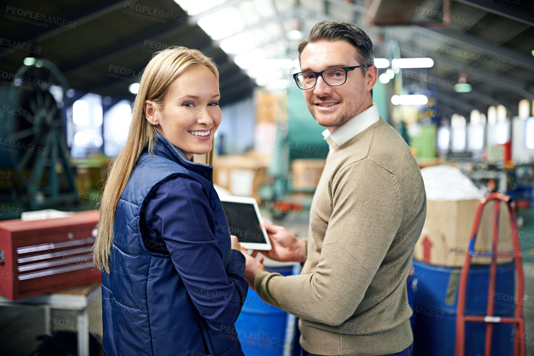 Buy stock photo Man, woman and tablet in factory for team management in export business, check emails and delivery. Male person, portrait and female employee with technology for warehouse inventory or stock. 