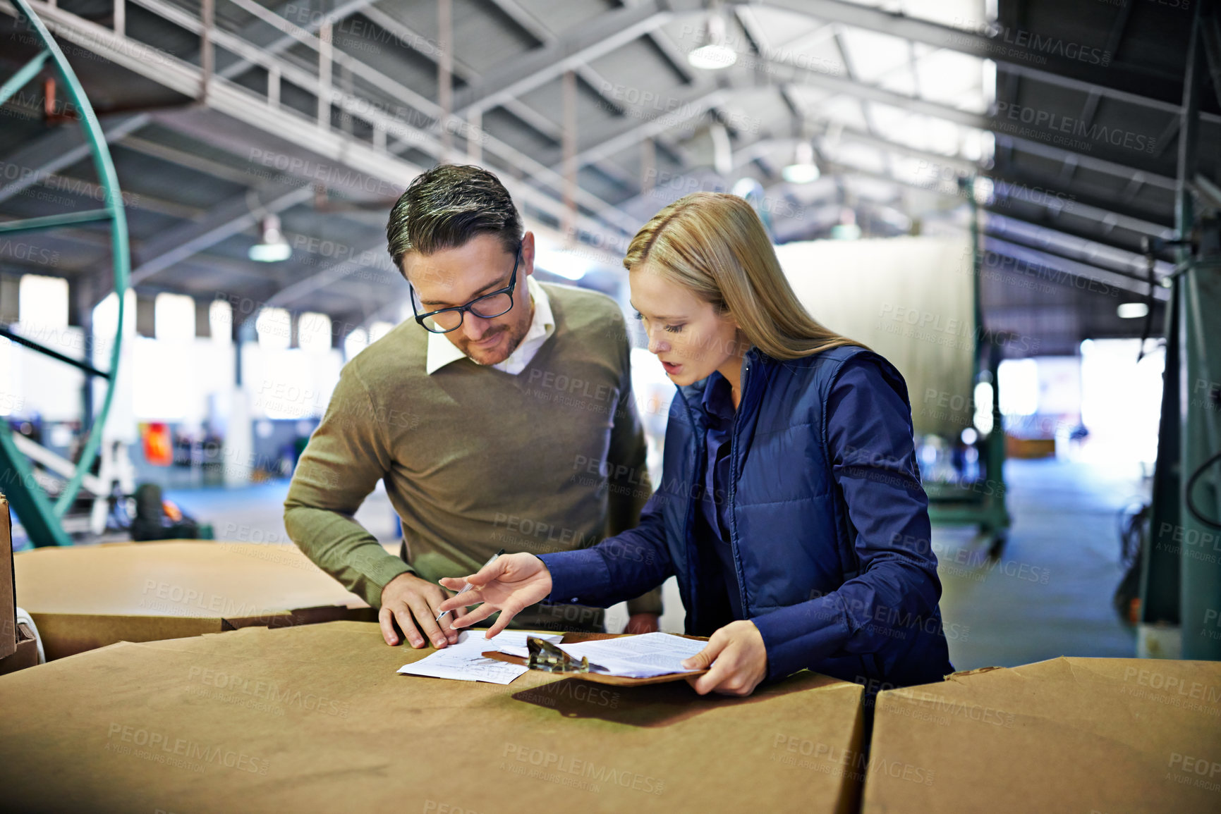 Buy stock photo Cropped shot of a two coworkers managing a warehouse