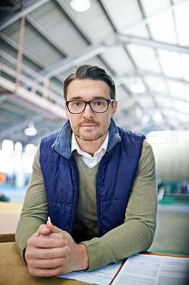 Buy stock photo Portrait, supervisor and businessman in logistics at factory with machines for supply chain. Mature man, warehouse and table with paperwork for stock take in manufacturing and distribution business 