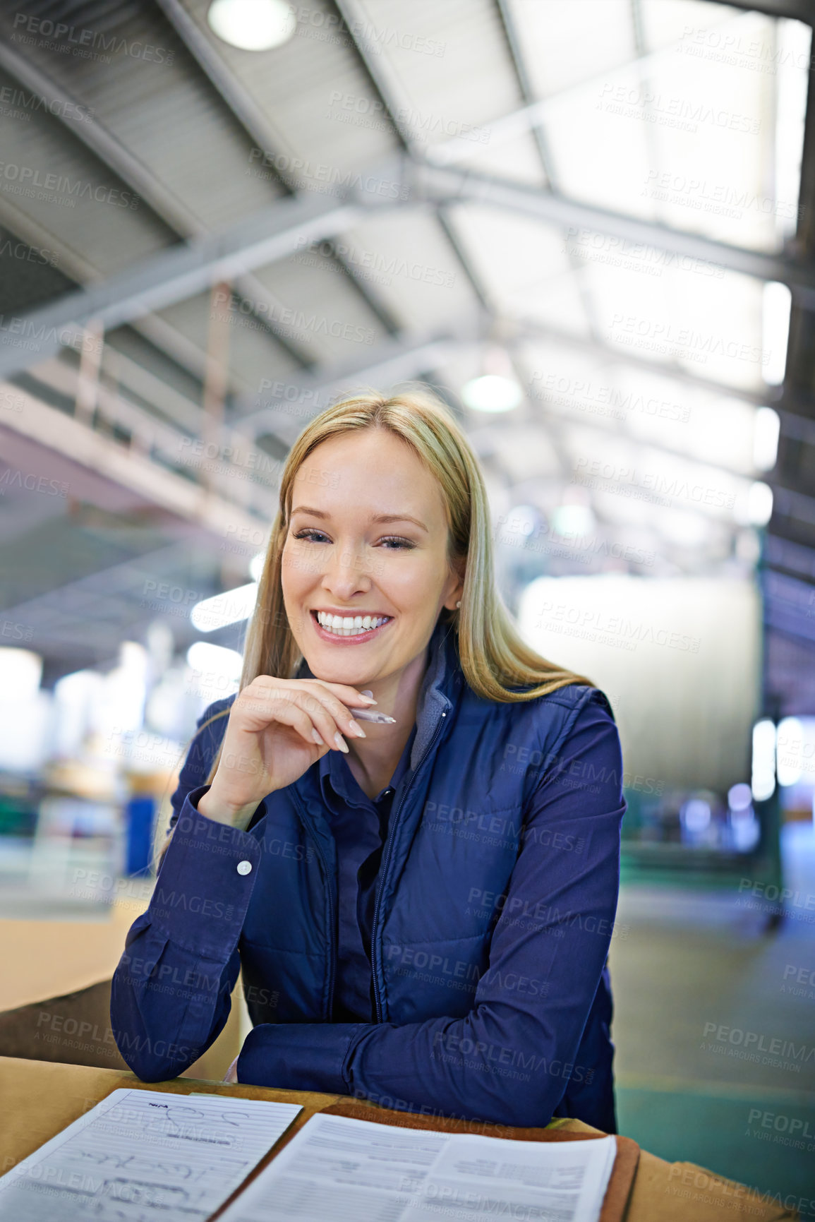 Buy stock photo Portrait, supervisor and happy as businesswoman in logistics at factory with machines for supply chain. Woman, warehouse and table with paperwork in manufacturing and distribution business with smile