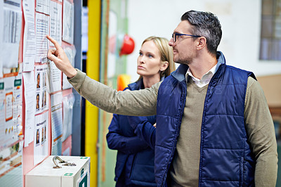 Buy stock photo People, planning and checking schedule with board in warehouse with calendar for order details. Man, woman and together with checklist or clipboard for supplier information and inventory updates