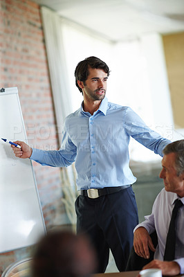 Buy stock photo Explain, presentation and businessman with whiteboard in office for company growth, budget or strategy. Professional, coach and male employee for profit, training or progress at Investment firm