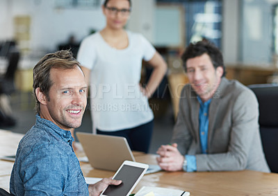 Buy stock photo Chairman, boss or Ceo looking confident, happy and cheerful during a meeting while browsing on a digital tablet in an office. Businessman feeling positive and proud after a team planning session