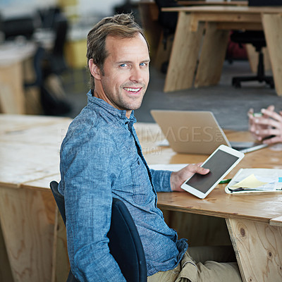 Buy stock photo Confident marketing manager browsing the internet on a digital tablet in an office. Handsome and happy professional researching creative ideas to promote and advertise a startup on social media