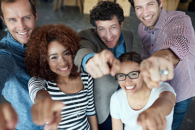 Buy stock photo Happy, fun and smiling group of office colleagues pointing and looking cheerful in a corporate office. Diverse group of business people looking cheerful and joyful while making a hand gesture at work