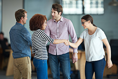 Buy stock photo Handshake showing success, support and trust between collaborating business men and women. Smiling, happy and diverse group or team of creative office colleagues making a deal, welcoming and greeting