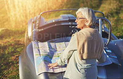 Buy stock photo Senior woman, car and lost outdoor with map for travel, retirement and sign on vacation. Elderly person, cobra and looking for direction or road in countryside with dementia while driving for holiday