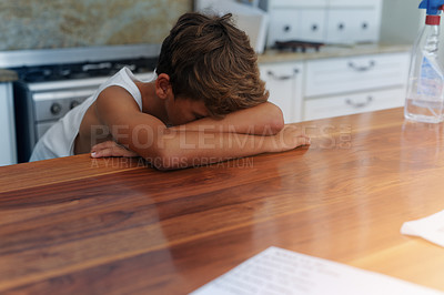 Buy stock photo Child, head and table for sad in home for emotional youth as tween for mistake, trouble or tired. Male person, boy and kitchen or unhappy stress in apartment for disappointment, depression or sleepy