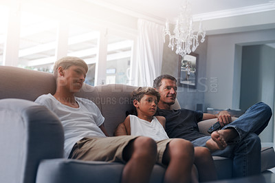 Buy stock photo Cropped shot of a father and his two young sons relaxing together at home