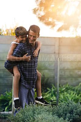 Buy stock photo Cropped shot of a father giving his son a piggyback ride outside